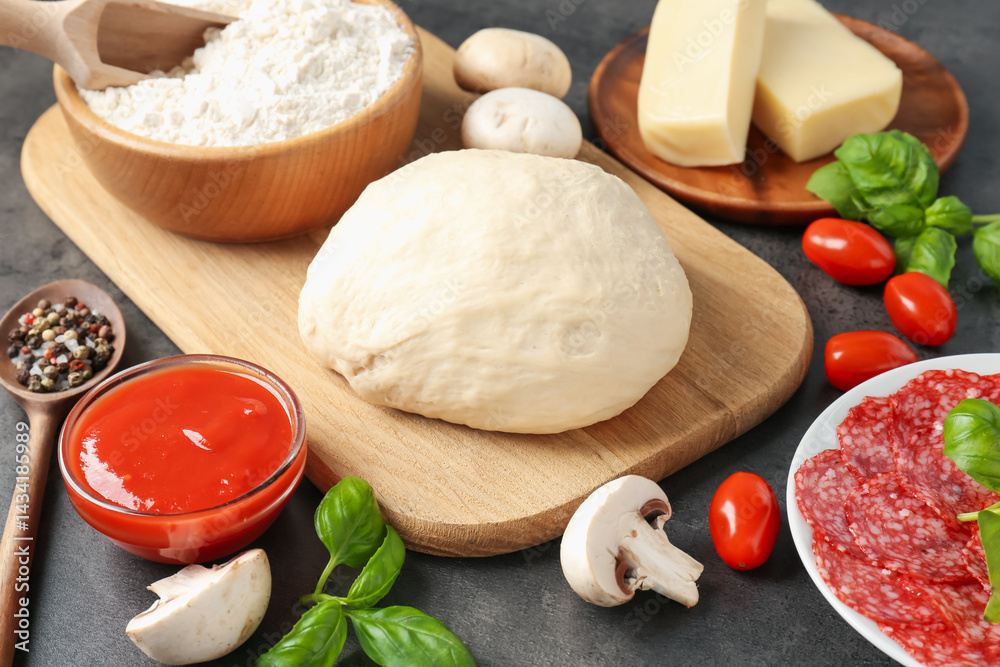 Fototapeta premium Making pizza. Different ingredients on gray textured table, closeup