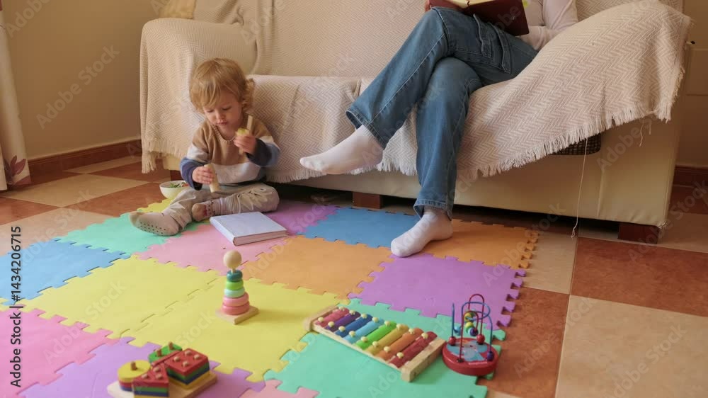 Mother Working Remotely While Supervising Toddler in Playful Home Environment Mother Working Remotely While Supervising Toddler in Playful Home Environment