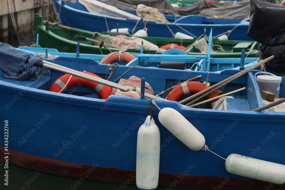 Boats moored to the pier. Details. Small boats on the water, close-up. Summer sunny day on the pier. Old boats. Vacation at sea