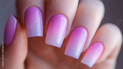 Detailed view of ombre nails blending soft pink and lavender hues.