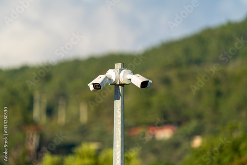 2 security cameras on the pole photo
