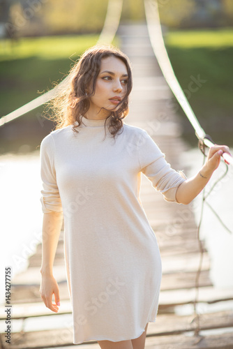 Obraz na płótnie Portrait of a beautiful young brunette woman in the park. Asian girl in a white sweater w salonie