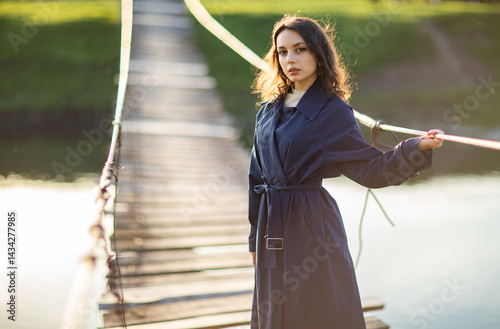 Portrait of a beautiful Asian woman with long black hair and wearing blue coat.