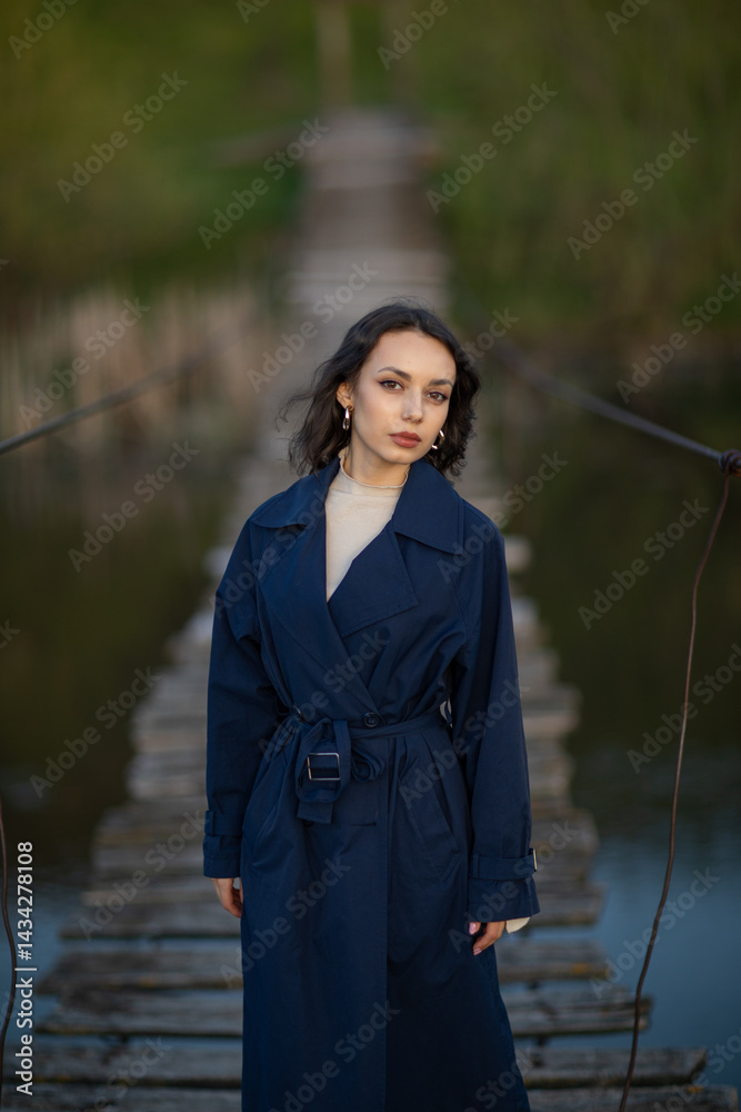 Portrait of a beautiful Asian woman with long black hair and wearing blue coat.