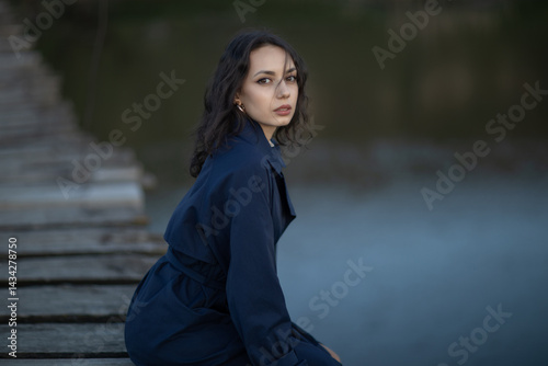 Obraz na płótnie Portrait of a beautiful Asian woman with long black hair and wearing blue coat. w salonie