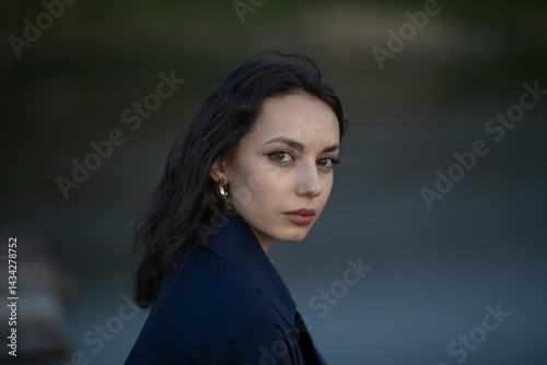 Obraz na płótnie Beautiful brunette meditates sadly in the park in the evening light. Sad girl w salonie