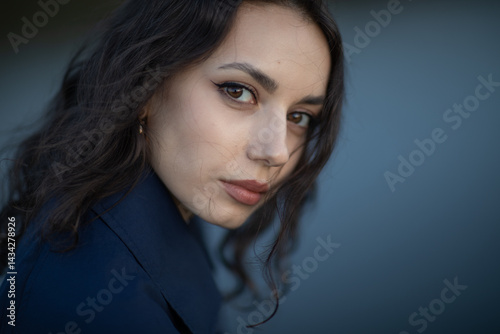 Obraz na płótnie Portrait of a beautiful Asian woman with long black hair and wearing blue coat. w salonie