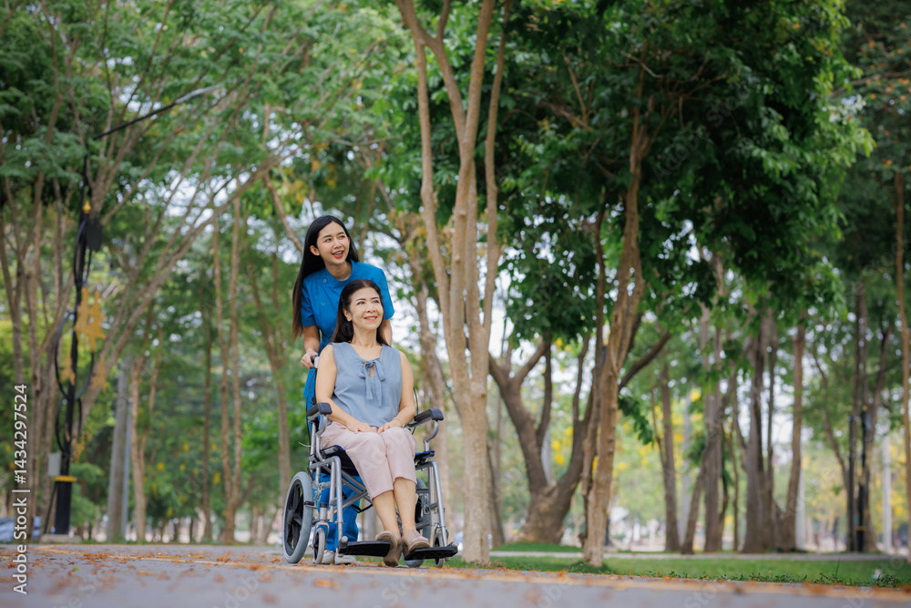 Obraz premium A dedicated physical therapist guides her patient in a wheelchair through the park, sharing a peaceful moment in the fresh outdoor air.