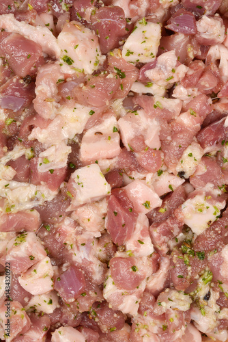 Obraz na płótnie A detailed close-up shows diced and seasoned pork meat, prepared with herbs and spices for making sausages w salonie