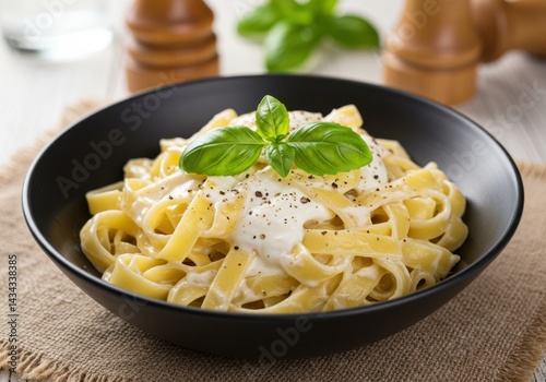 Pasta with cream and basil isolated on white background