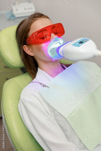 teeth whitening, Dentist starting teeth, whitening procedure, white teeth, receiving teeth cleaning