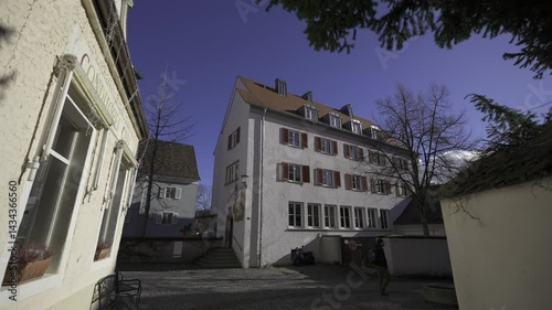 Charming Lindau im Bodensee, Bavaria picturesque medieval town on Lake Constance. Colorful facades, cobblestone streets, houses, alleys, authentic German heritage. Old downtown streets out of season.  photo