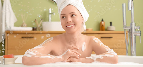Young woman with soap bubbl...
