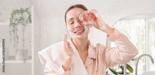 Young woman with soap washi...