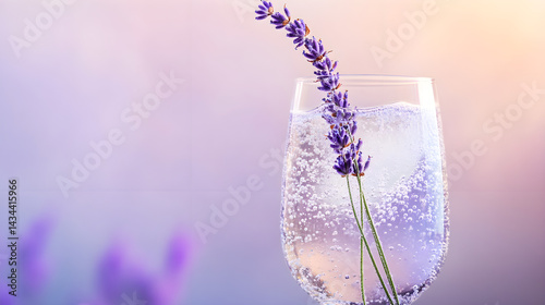A crystal-clear glass of lavender lemon spritz with effervescent bubbles rising to the top, garnished with a delicate sprig of fresh lavender, set against a soft pastel background 