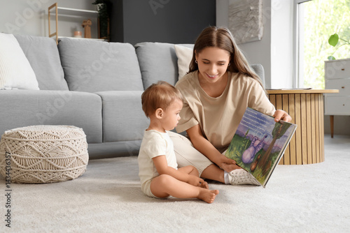 Mother reading book to her ...