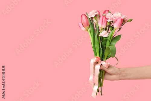 Female hand with bouquet of...