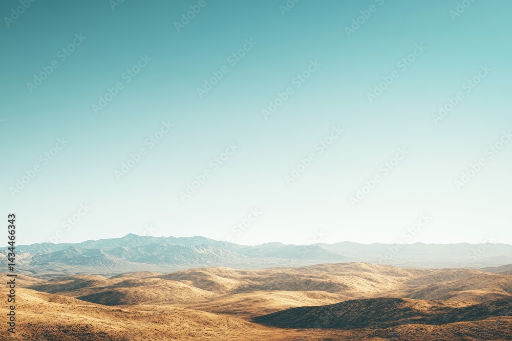 Naklejka premium Vast, arid landscape under a clear, pale blue sky. Rolling hills extend to distant mountains.