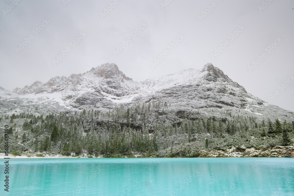 Lake Sorapis, Dolomites, Italy. Lake and reflections on the water surface. Mountain landscapes with turquoise water. Place for mountain hiking, travel and vacation. Wallpaper, postcard, photo.