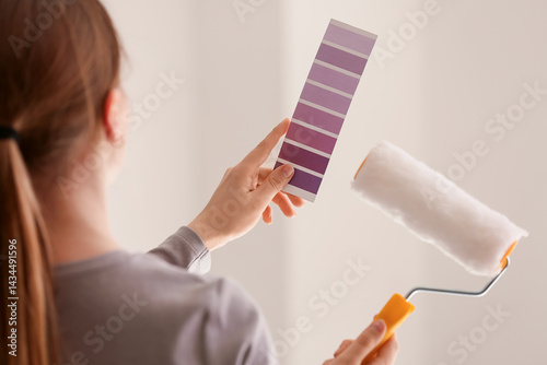 Woman holding purple paint ...