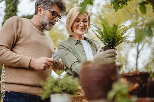 Wallpaper Mural Happy mature couple gardening and watering potted plants outdoor Torontodigital.ca