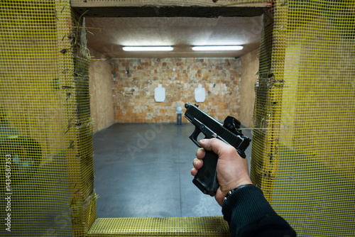 Wallpaper Mural First person view: shooter aims a pistol at targets in a safe indoor shooting range, practicing weapon proficiency. Torontodigital.ca