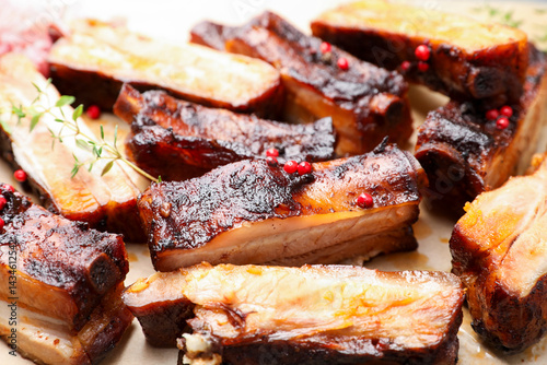 Bild auf Leinwand Delicious pork ribs and thyme on parchment paper, closeup