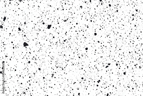 A white background with a scattered pattern of black ink splatter