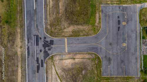 Vertical view of passenger terminal and stopping point for planes and helicopters on small airfield