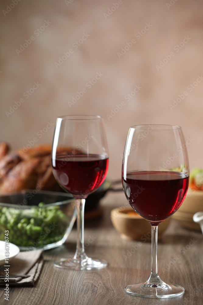 Red wine and delicious dinner served on wooden table Red wine and delicious dinner served on wooden table