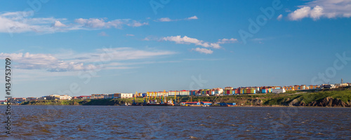 Obraz na płótnie Panorama of the city of Anadyr. Chukotka, Russian Far East. View of the city from the Anadyr Estuary. In the distance is a seaport and colorful buildings. Summer arctic landscape. w salonie