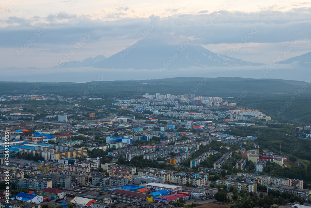 Morning cityscape. Top view of the buildings and streets of the city. Residential urban areas at twilight at dawn. A volcano in the distance. Petropavlovsk-Kamchatsky, Kamchatka, Far East of Russia.