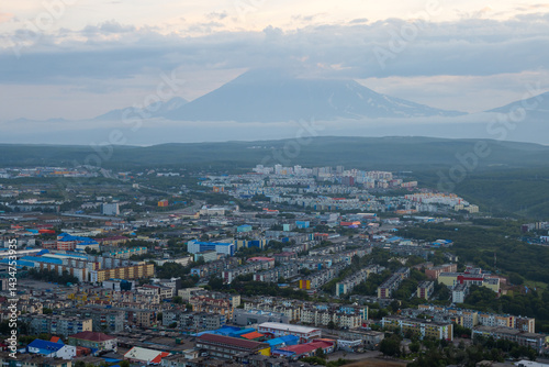 Obraz na płótnie Morning cityscape. Top view of the buildings and streets of the city. Residential urban areas at twilight at dawn. A volcano in the distance. Petropavlovsk-Kamchatsky, Kamchatka, Far East of Russia. w salonie