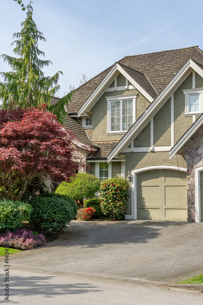 Garage door in luxury house with trees and nice landscape in Spring in Vancouver, Canada, North America. Day time on April 2025. Garage door in luxury house with trees and nice landscape in Spring in Vancouver, Canada, North America. Day time on April 2025.