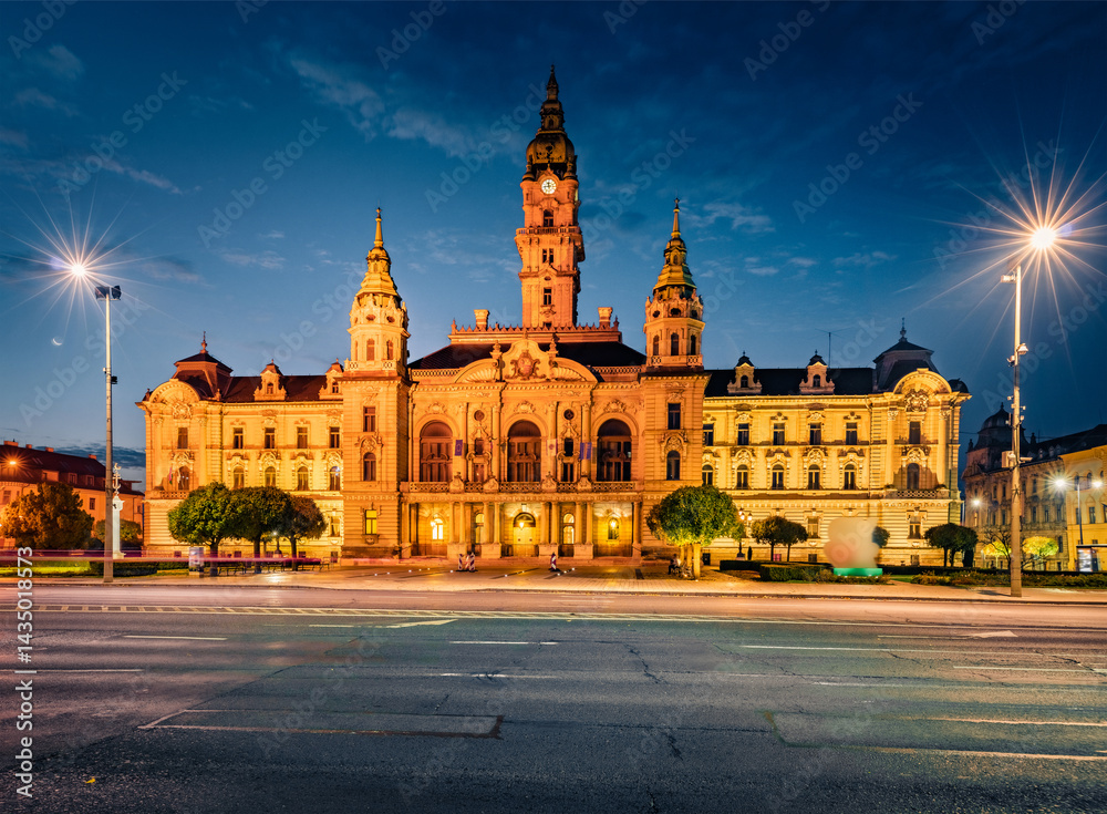 Illuminated autumn view of Town Hall with empty street. Dramatic morning cityscape of Gyor town, capital of Gyor-Moson-Sopron County and Western Transdanubia region, Hungary, Europe.