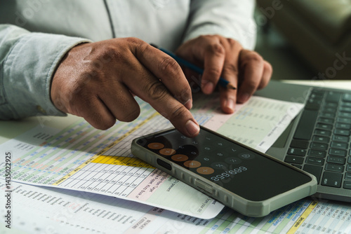 Obraz na płótnie businessman uses a calculator and paperwork to analyze finances, investments, and tax reports at his desk calculator and digital tablet. business financial reports and data analysis w salonie