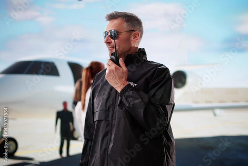 Obraz na płótnie Security Guard Protecting A VIP Near A Private Jet w salonie