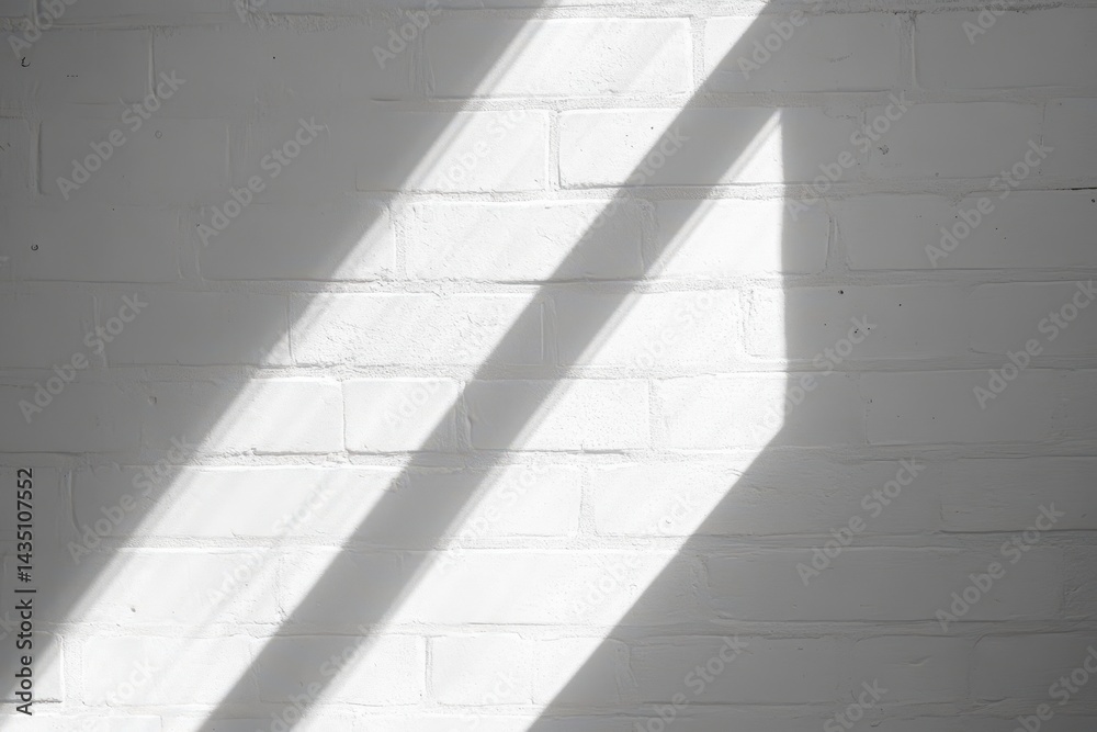 Obraz premium Sunlight casts diagonal shadows on a white brick wall