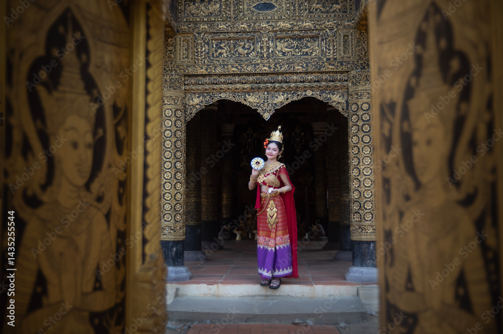 Beautiful young woman wearing Thai Songkran costume, a regional Thai costume dress in Chiang Mai, Thailand.