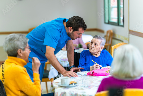 Obraz na płótnie Male nurse assisting elderly woman with recreational activity in nursing home w salonie