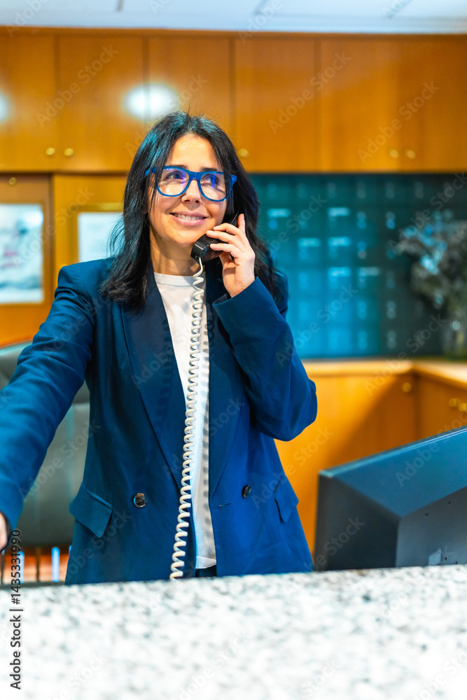 Smiling receptionist answering phone at nursing home reception desk