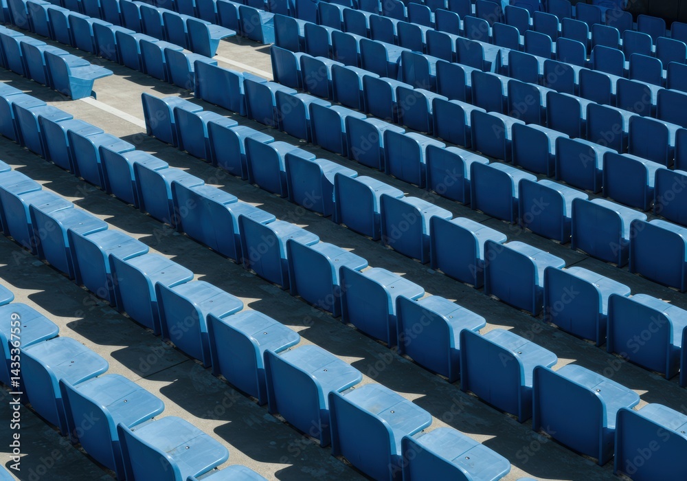 Naklejka premium A high-angle shot shows rows of blue stadium seats under the bright, sunny sky.
