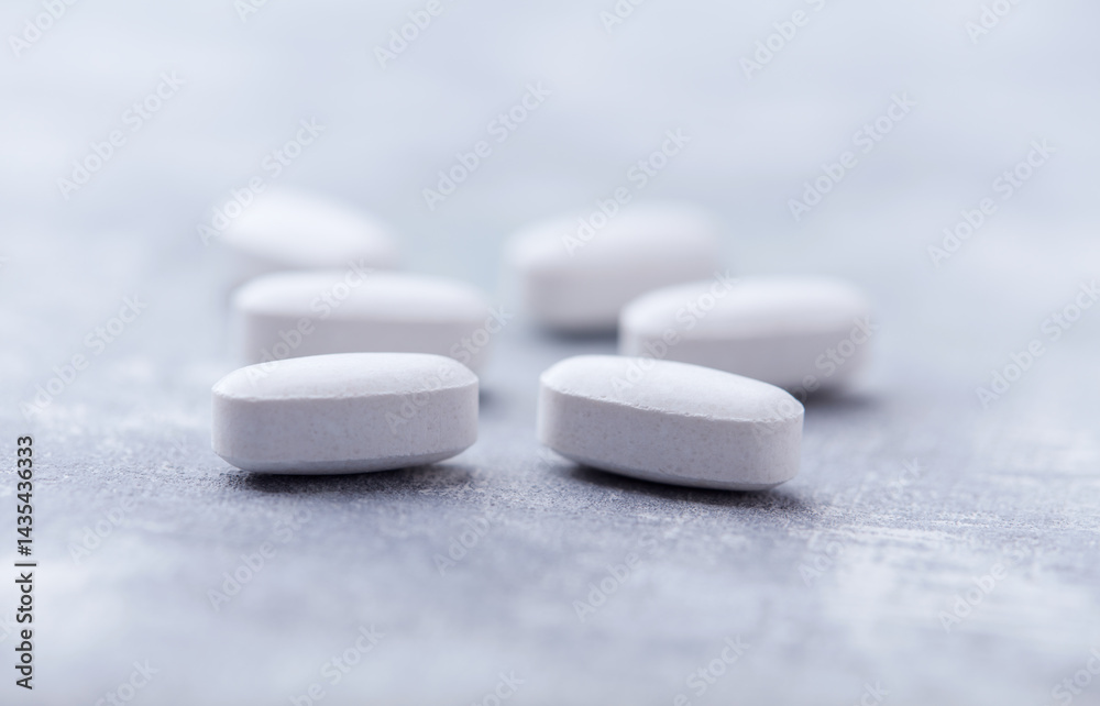 Amino acids tablets on wooden background. Soft focus. Close up Amino acids tablets on wooden background. Soft focus. Close up