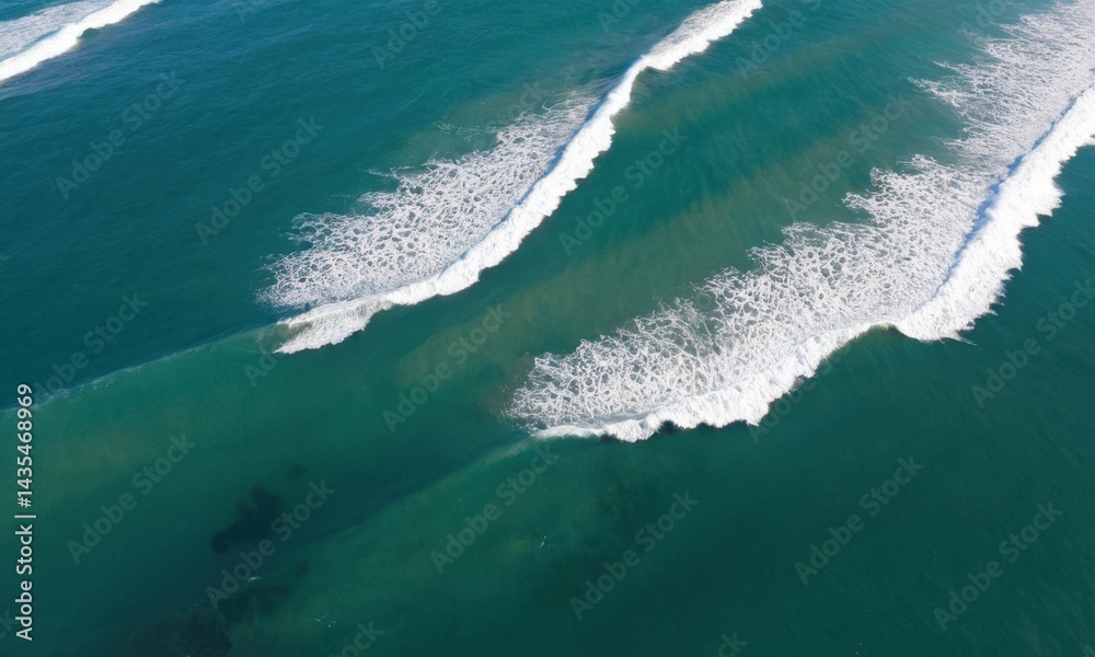 Two people surfing in the ocean from above