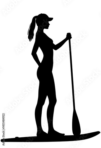 Silhouette of a woman paddling on a stand-up paddleboard  