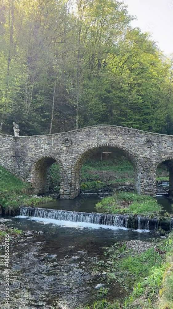 old bridge over a small river in the park