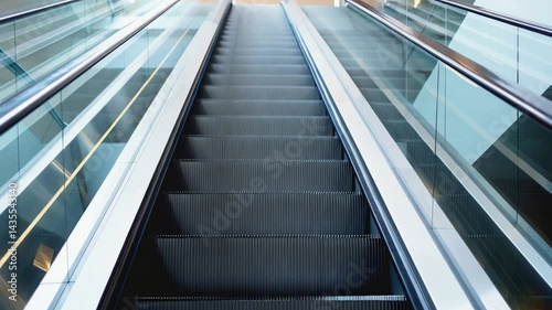Wallpaper Mural Low-angle shot looking up an empty escalator. The steps are grey with black treads, and the handrails are stainless steel with white or light-colored side panels Torontodigital.ca