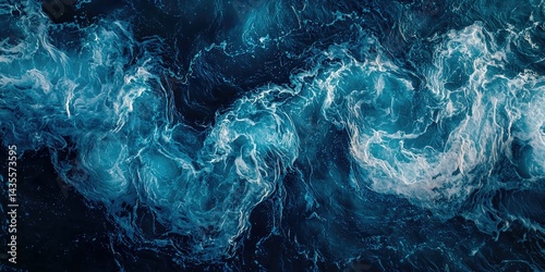 An aerial view capturing the swirling, foamy wake of a boat cutting through deep blue waters.