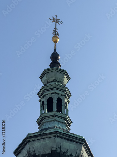 Obraz na płótnie crucifix stands tall on the bell tower of a church w salonie