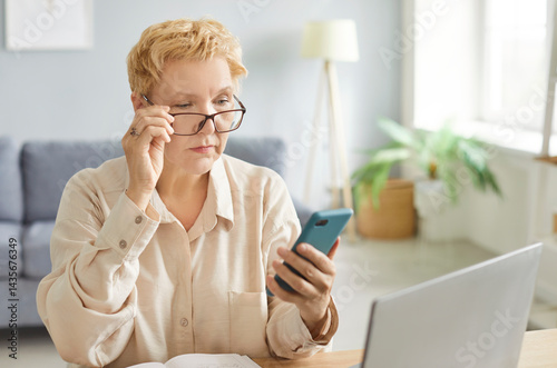 Serious focused woman, pensive lady using mobile phone for work at desk, communication, thinking on problems, reading online chat message, cellphone call, social media network, looking in glasses